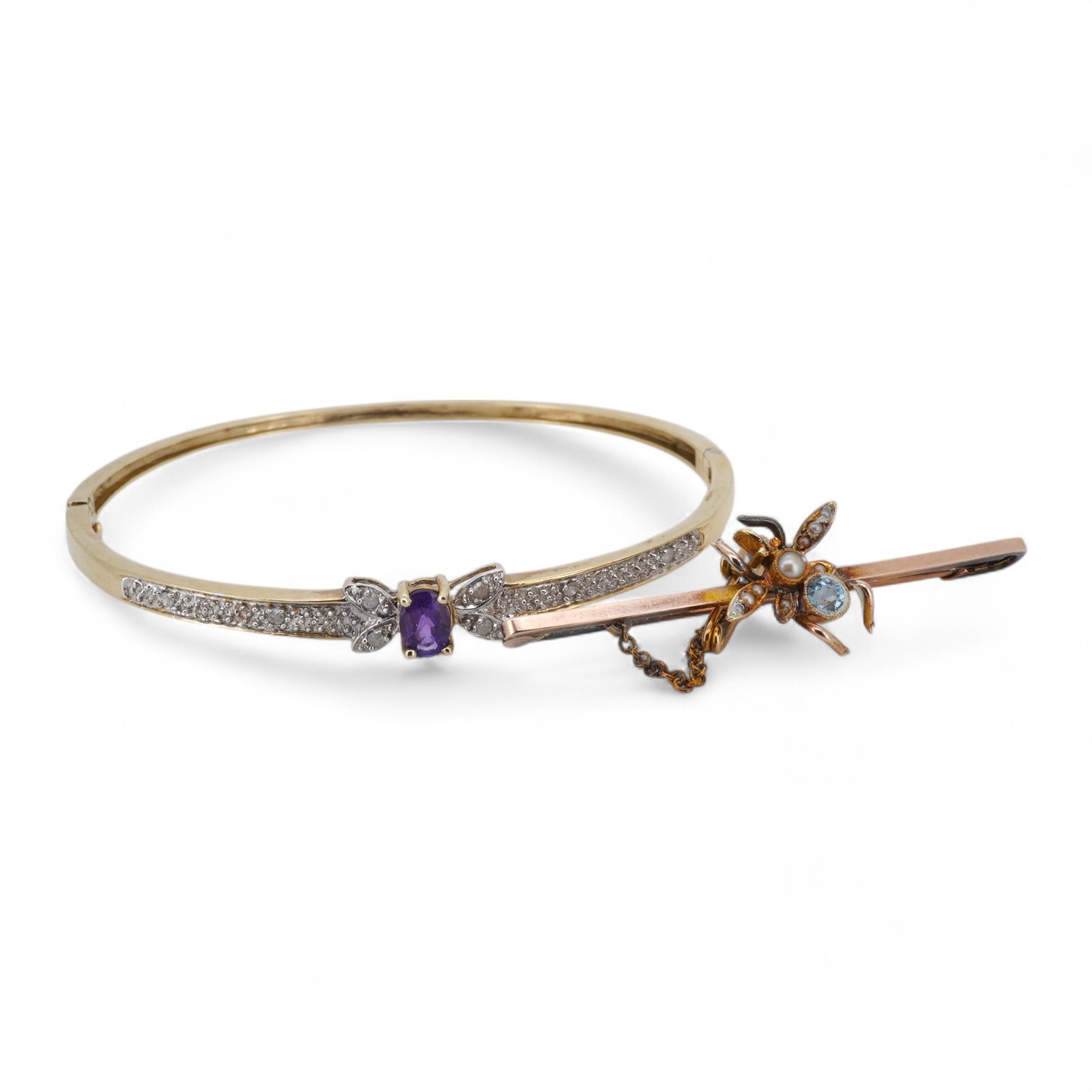 An amethyst and diamond bangle, inner circumference 17.5cm, mounted in gold, gross weight 7 grams; and an Edwardian bar brooch designed as an insect, set with a circular-cut aquamarine and seed pearls, mounted in gold, l